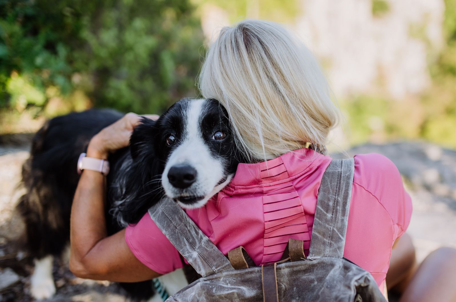 woman hugging border collie dog