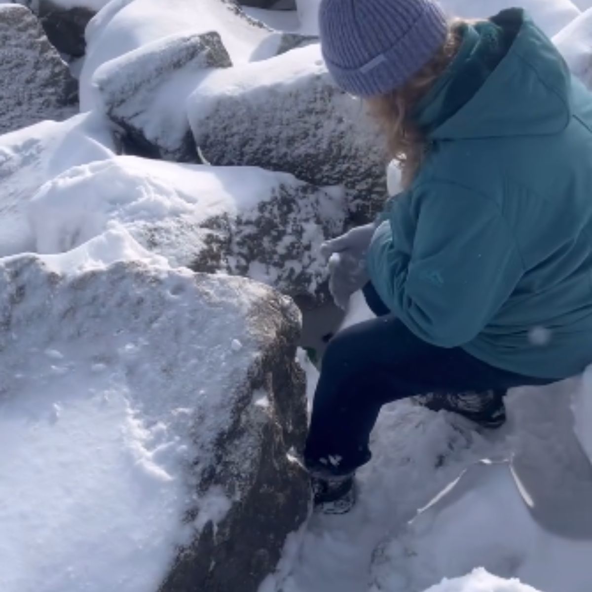 woman on snowy rocks