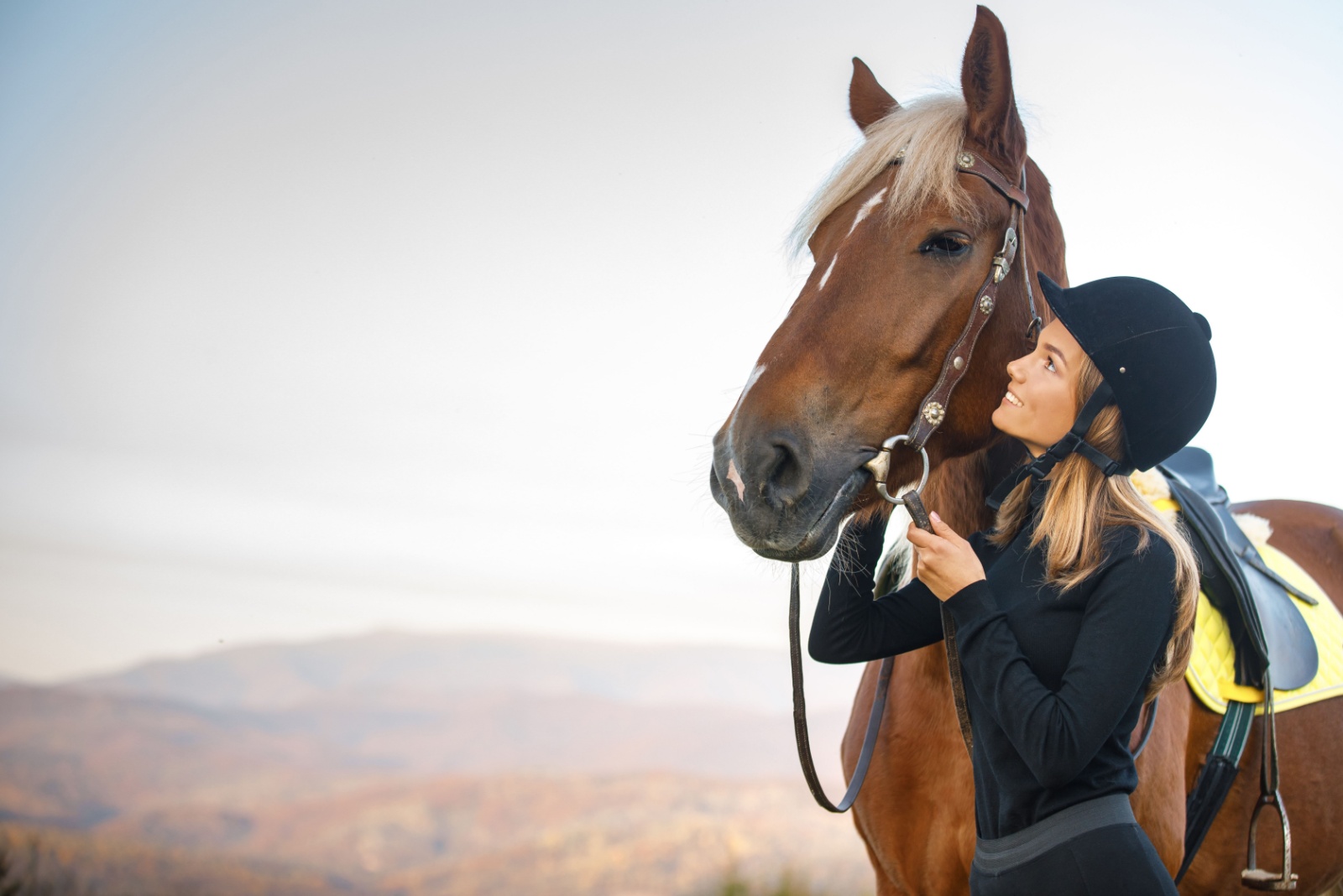 woman standing next to a horse