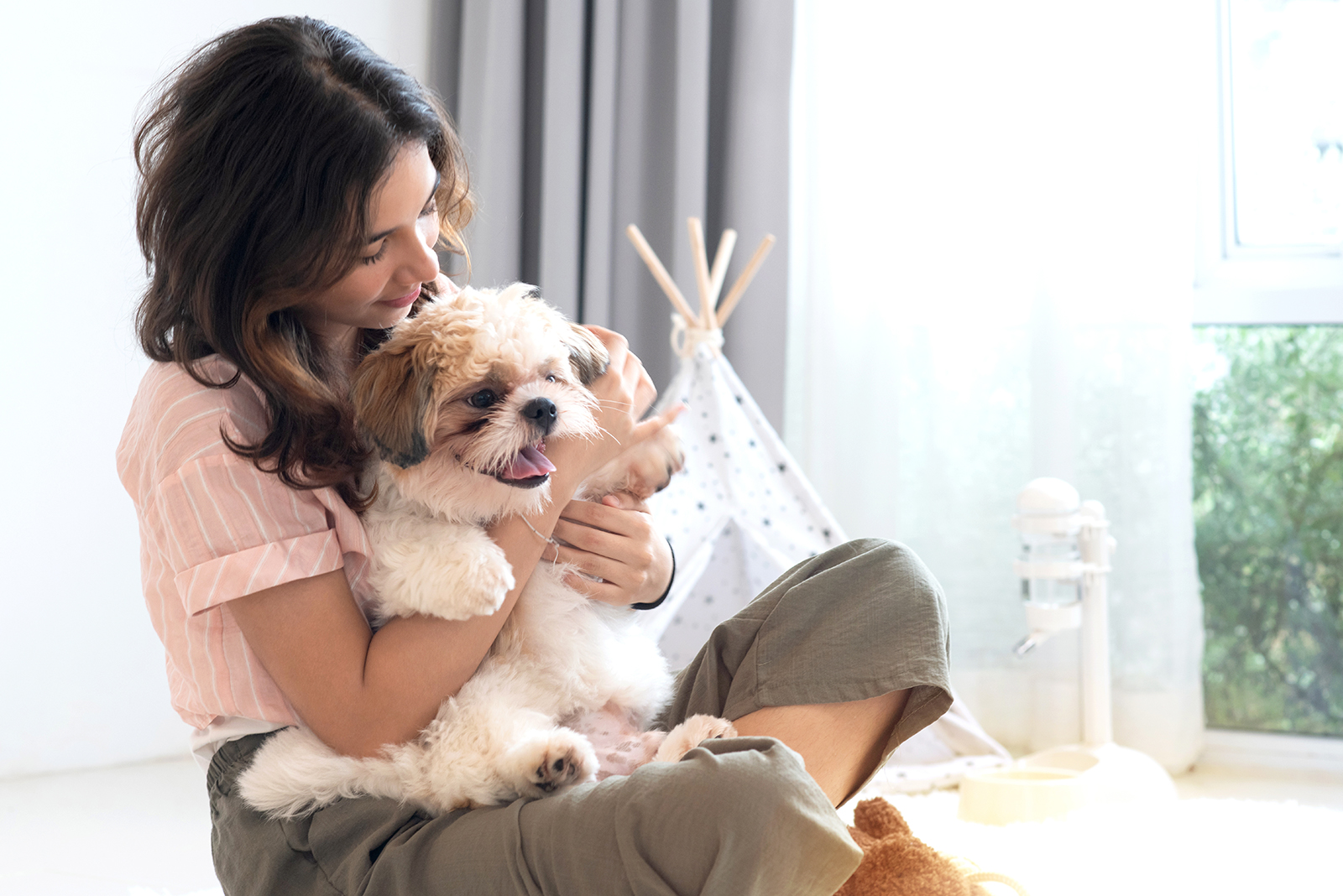 Woman holding Shih Tzu